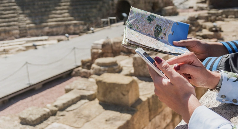 Tourists exploring ancient ruins with map