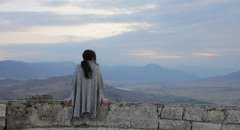 Woman overlooking mountain landscape