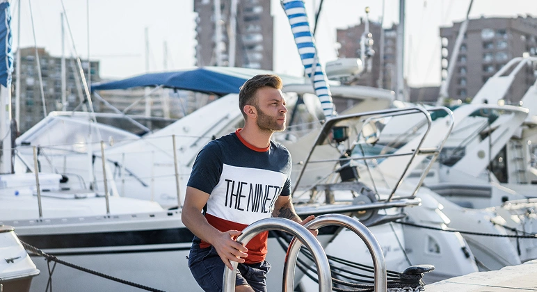 Man in color-block T-shirt at marina