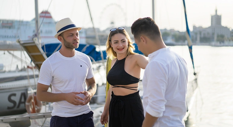 Friends chatting at a marina near boats